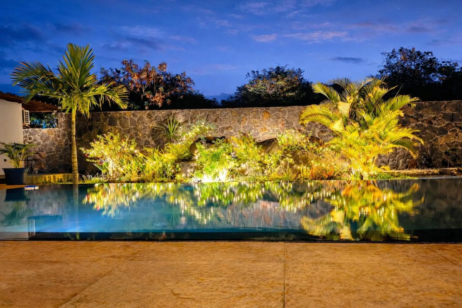 The infinity pool lit up at dusk